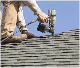roofers performing emergency roofing repair work